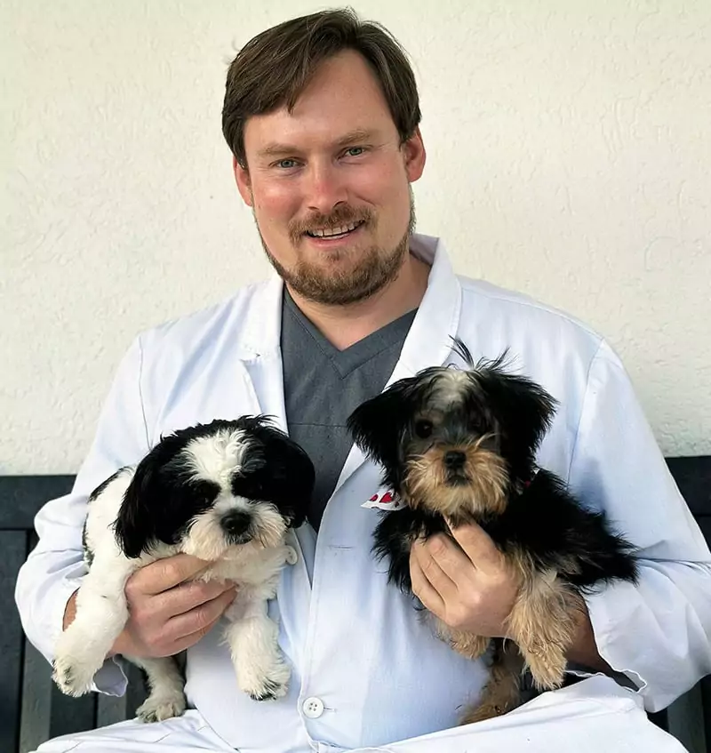 Dr. Phil Good holding rescue dogs at Beyond Pets Animal Hospital